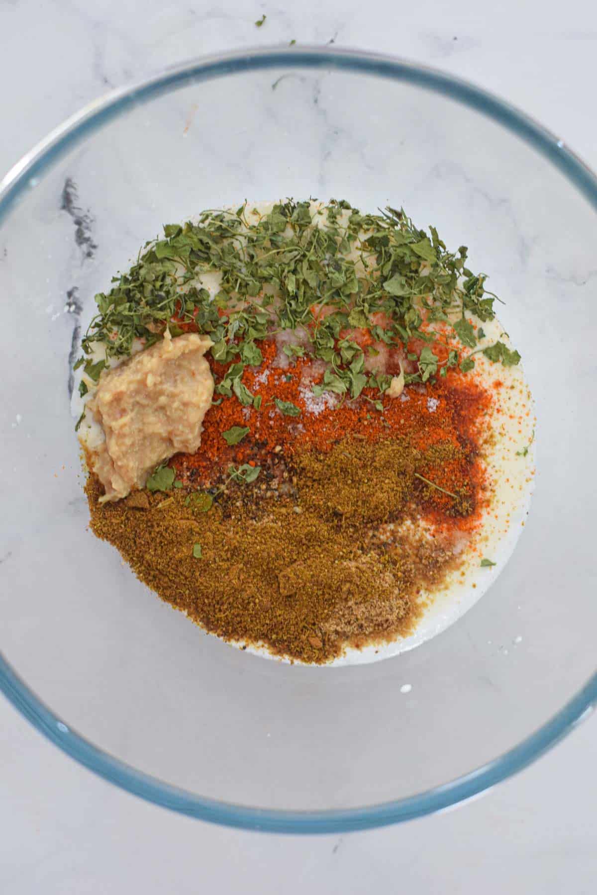 A bowl of spices and herbs used for air fryer chicken tikka wrap.
