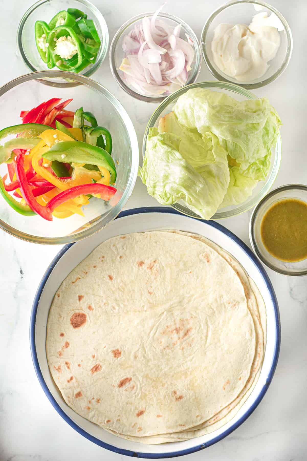 A wrap with tortillas, salsa, and other ingredients.