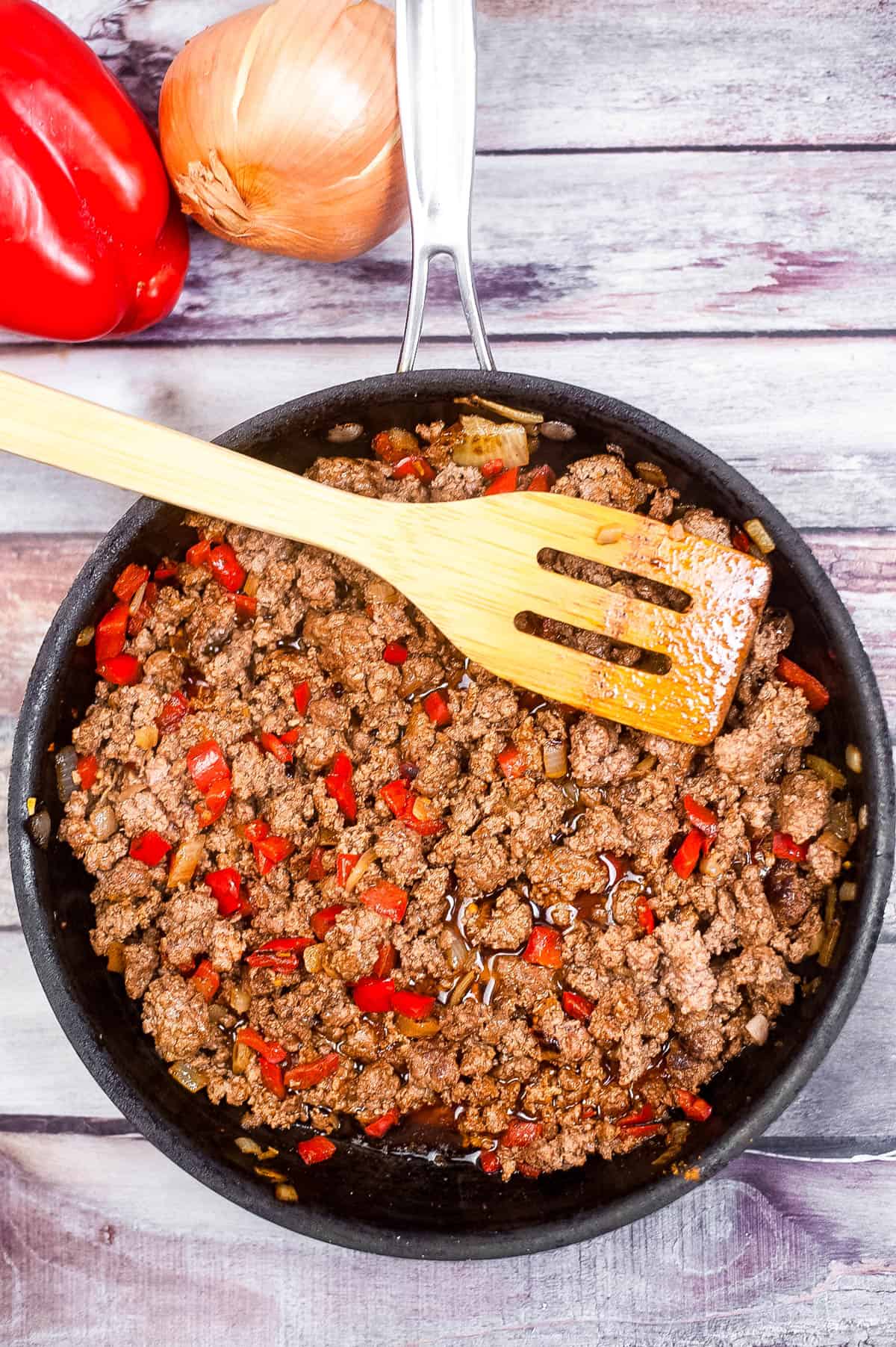 A skillet filled with ground beef prepared in an air fryer.