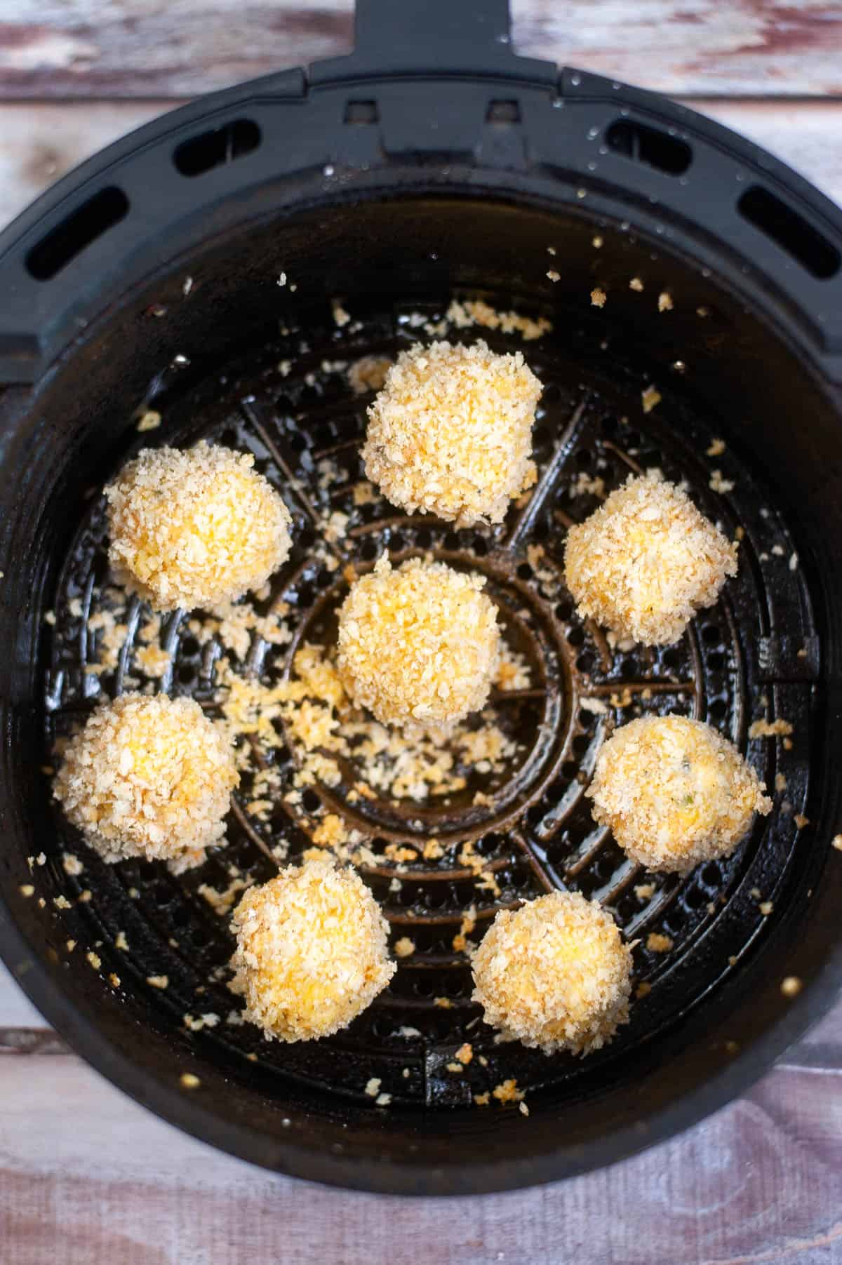 The air fryer is filled with jalapeno popper bites.