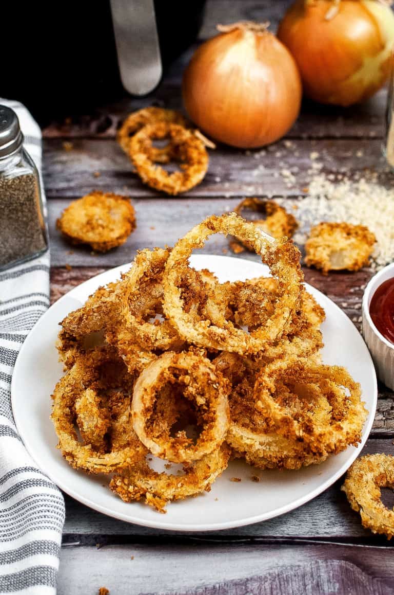 low angle shot of a plate of air fried onion rings.