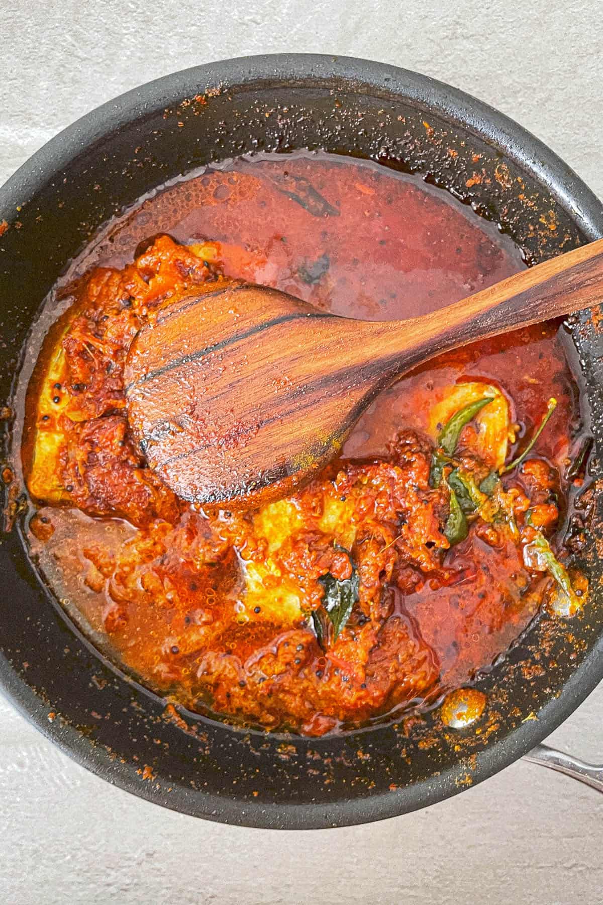 A cooking utensil containing kerala fish curry.