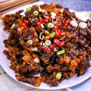 Close up shot of a plate of crispy chilli beef.