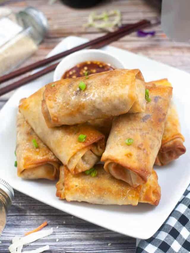 Chinese spring rolls on a white plate.