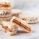 dulce de leche sandwich cookies on a marble trivet.