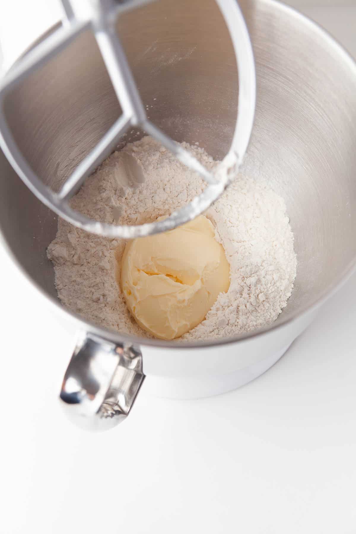 A metal mixing bowl with dulce de leche cookies dough mixture.