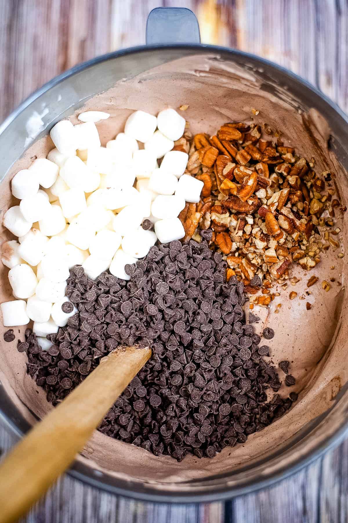 Marshmallows, pecans, and chocolate chips added to the mixture in the bowl.