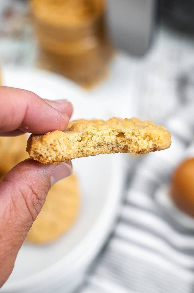 Close up of an air fryer peanut butter cookie with a bite out of it.