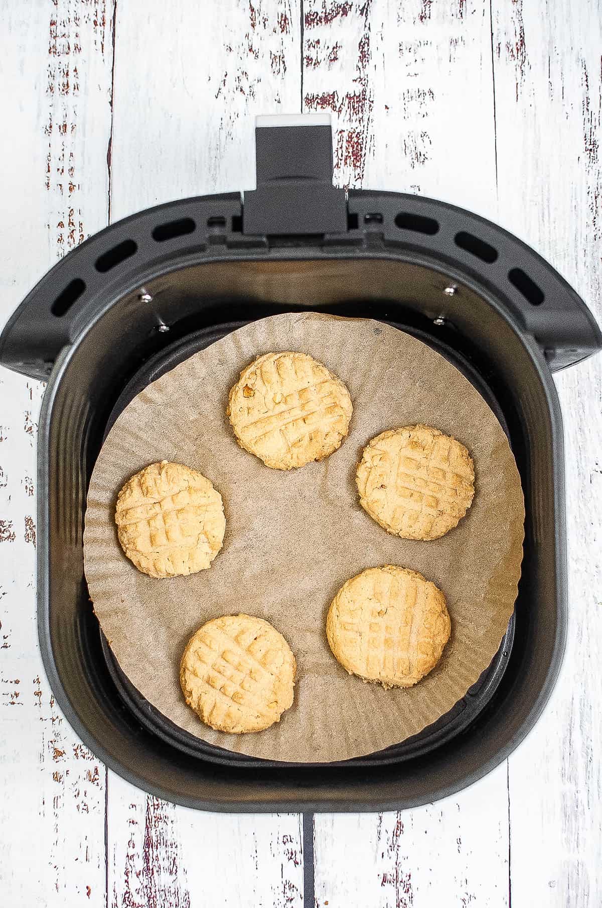 baked cookies in the air fryer basket.