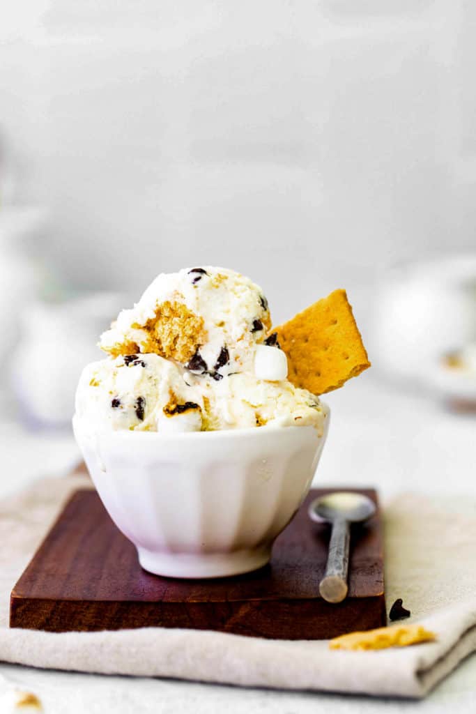 low angle shot of a bowl of s'mores ice cream with a graham crackers.
