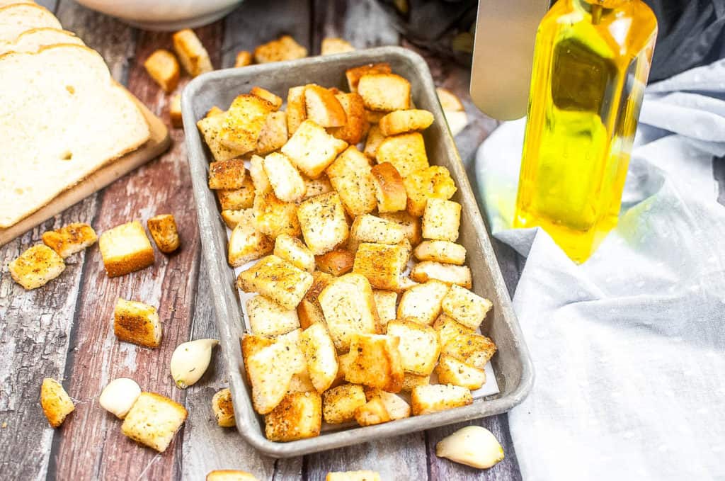 Low angle shot of croutons in a baking pan.