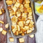 Overhead shot of croutons on a baking pan.