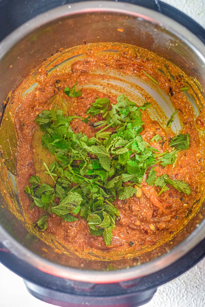An instant pot filled with shrimp and biryani sauce.