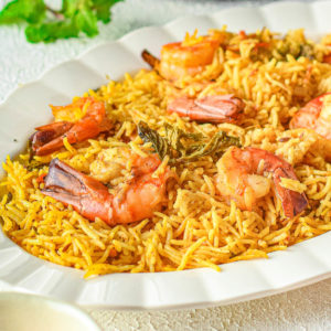 A plate of Instant Pot shrimp biryani on a table.