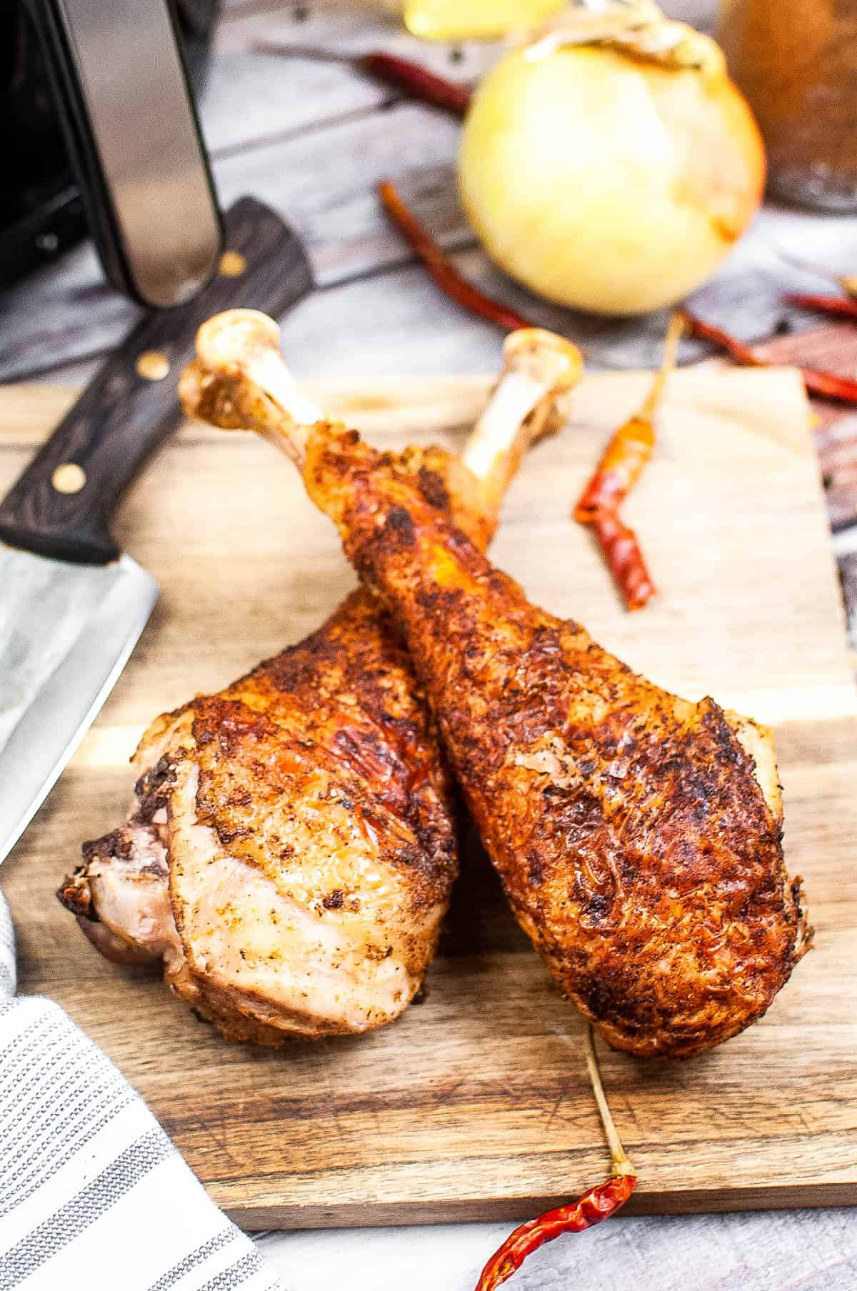 air fryer turkey legs on a cutting board.