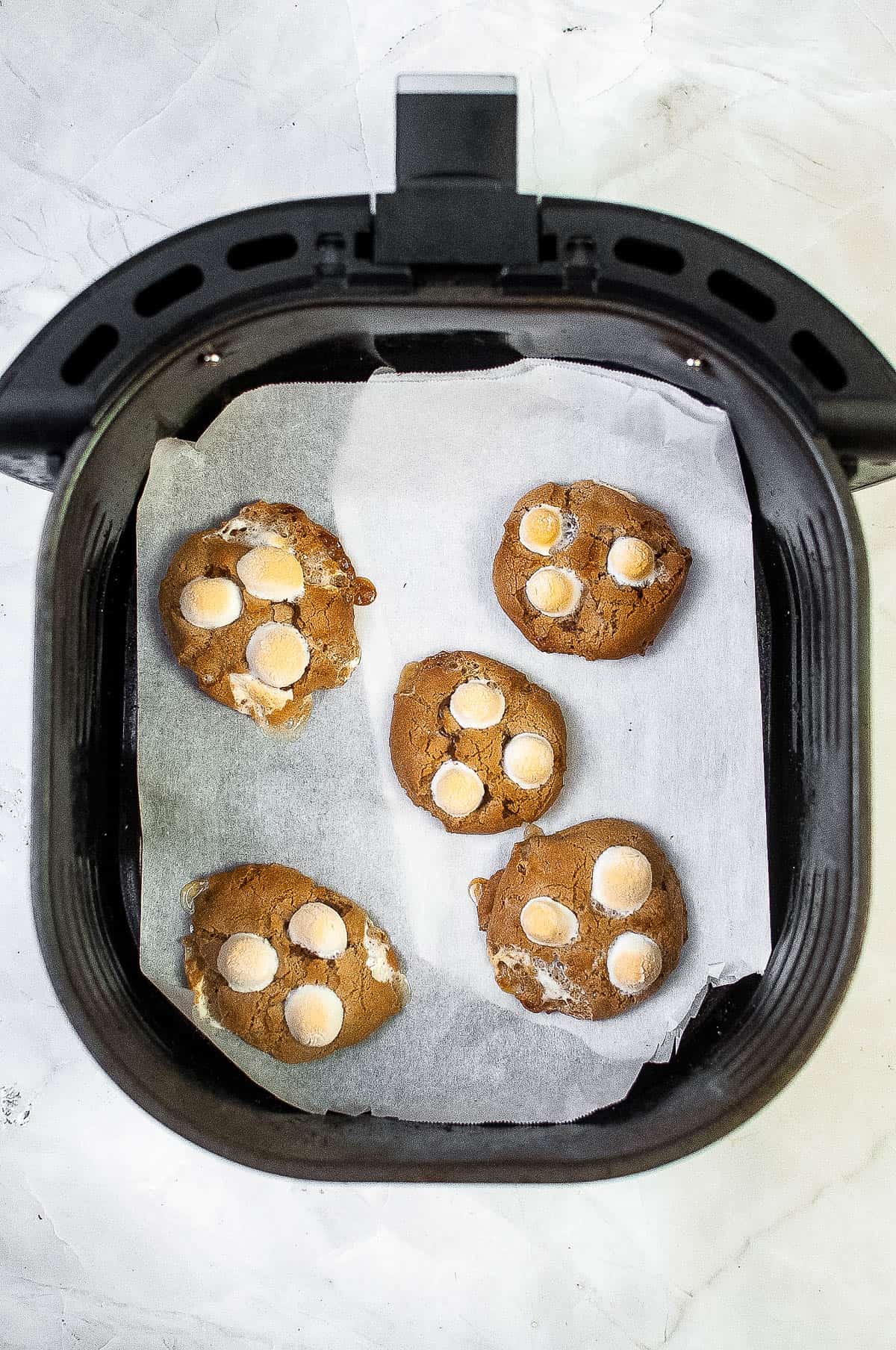An air fryer filled with hot cocoa cookies.
