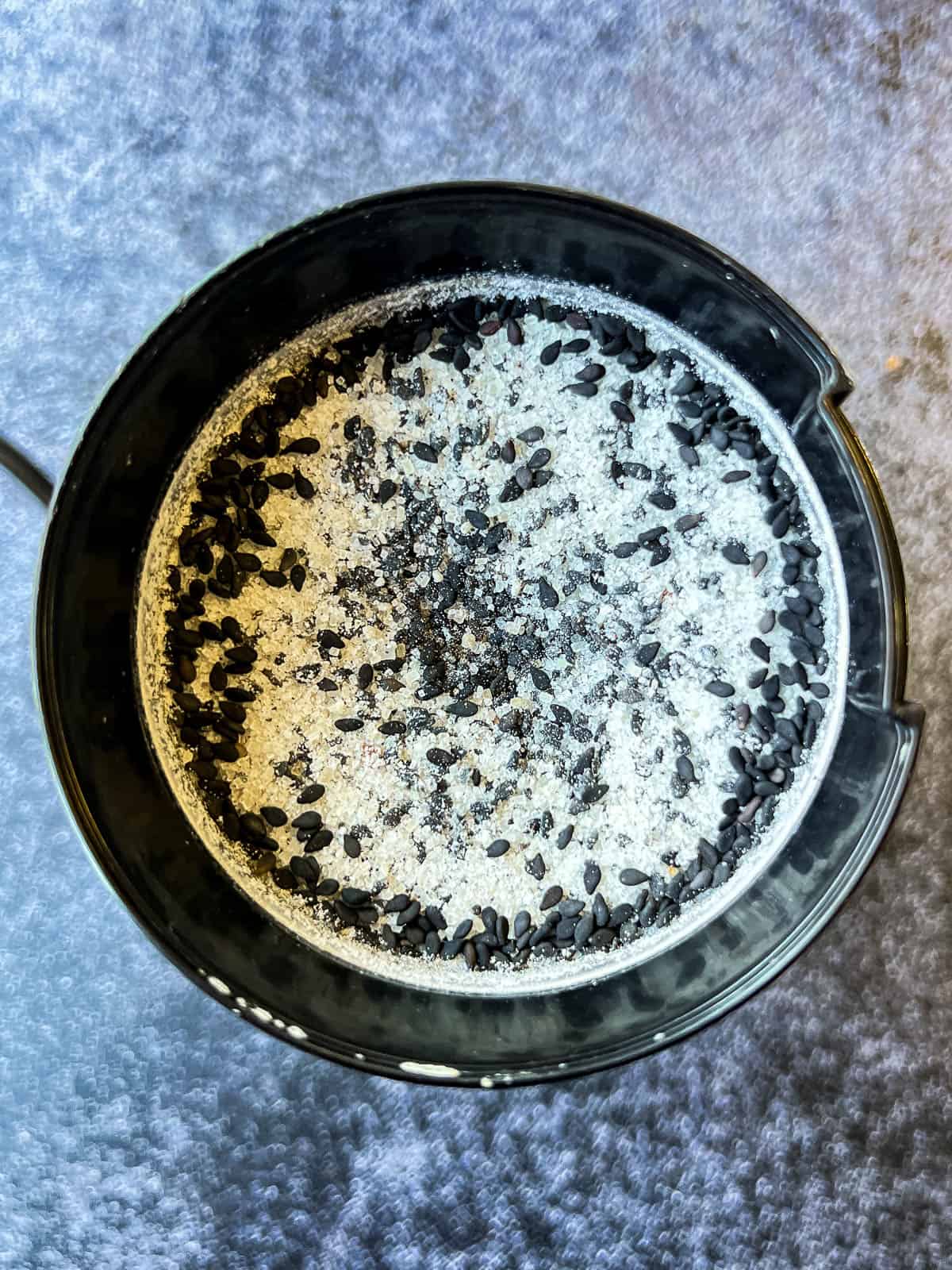 grinding sugar and sesame seeds in a spice grinder.