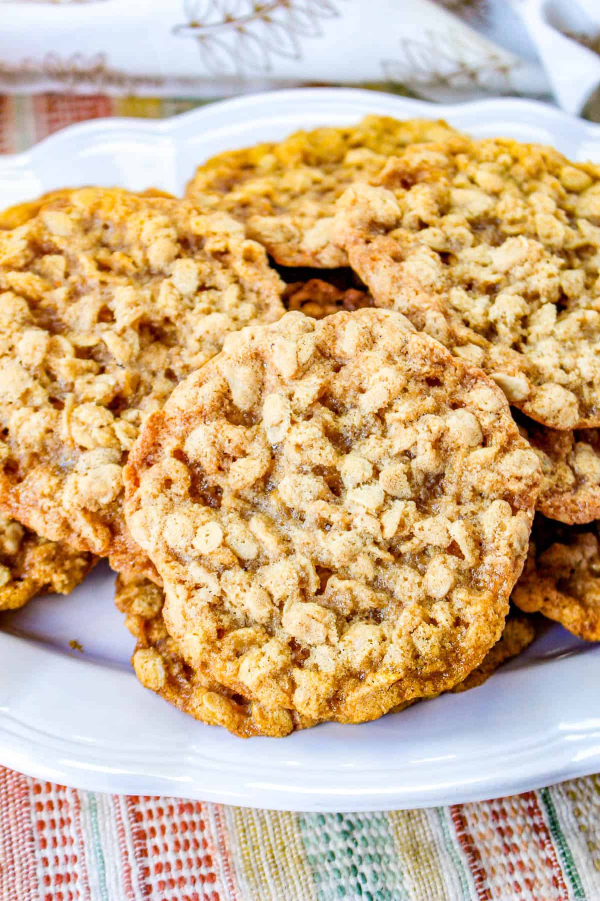 closeup low angle shot of oatmeal cookies on a white plate.