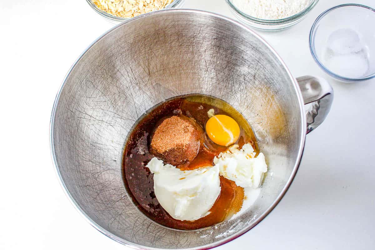 A metal bowl with eggs, flour and other ingredients for making Quaker oatmeal cookies.