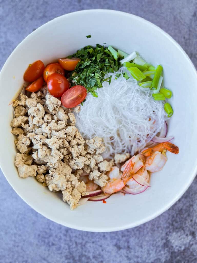 Vietnamese yum Woon Sen noodle bowl with shrimp, meat, and vegetables.