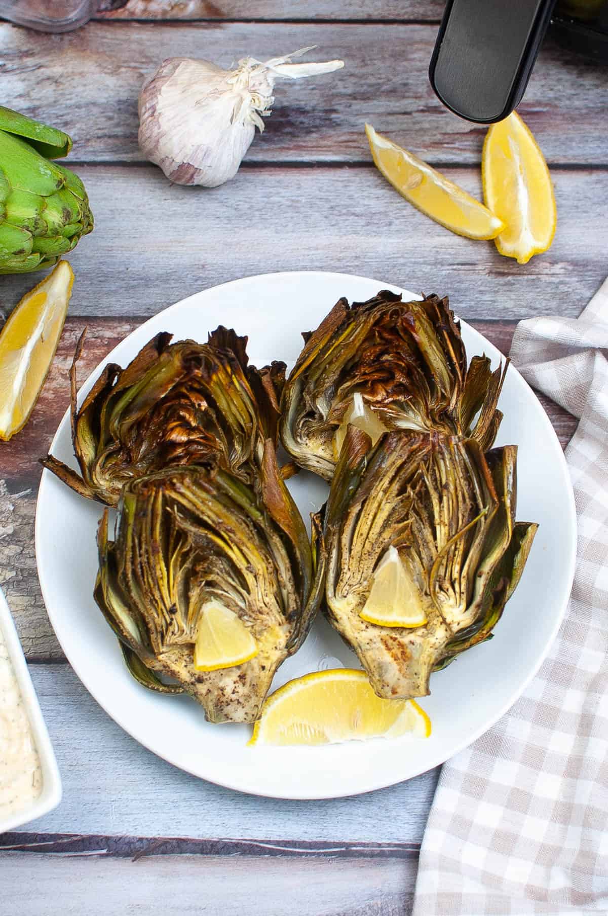 high angle shot of a plate of artichokes cooked in the air fryer.