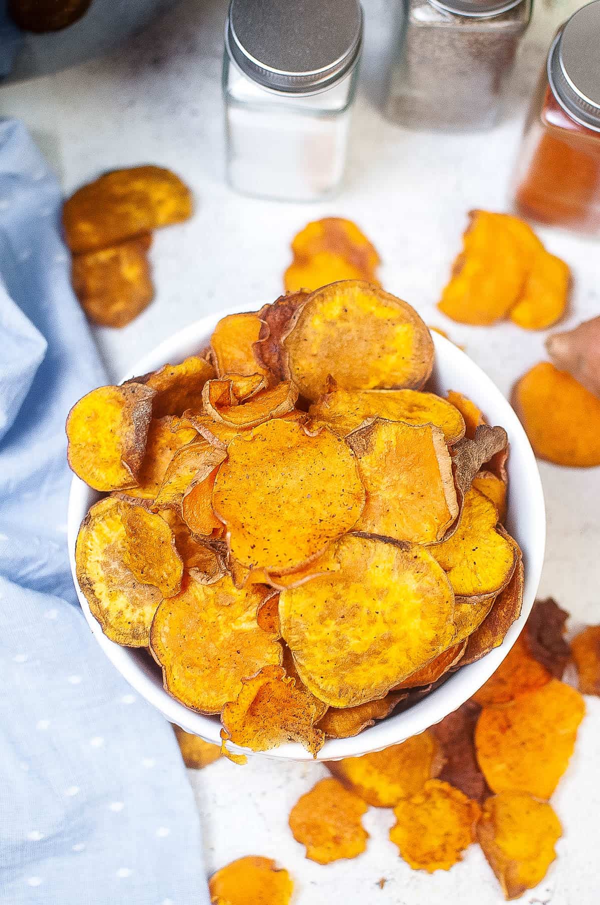 Low angle shot of a bowl of crispy sweet potato chips made in the air fryer.