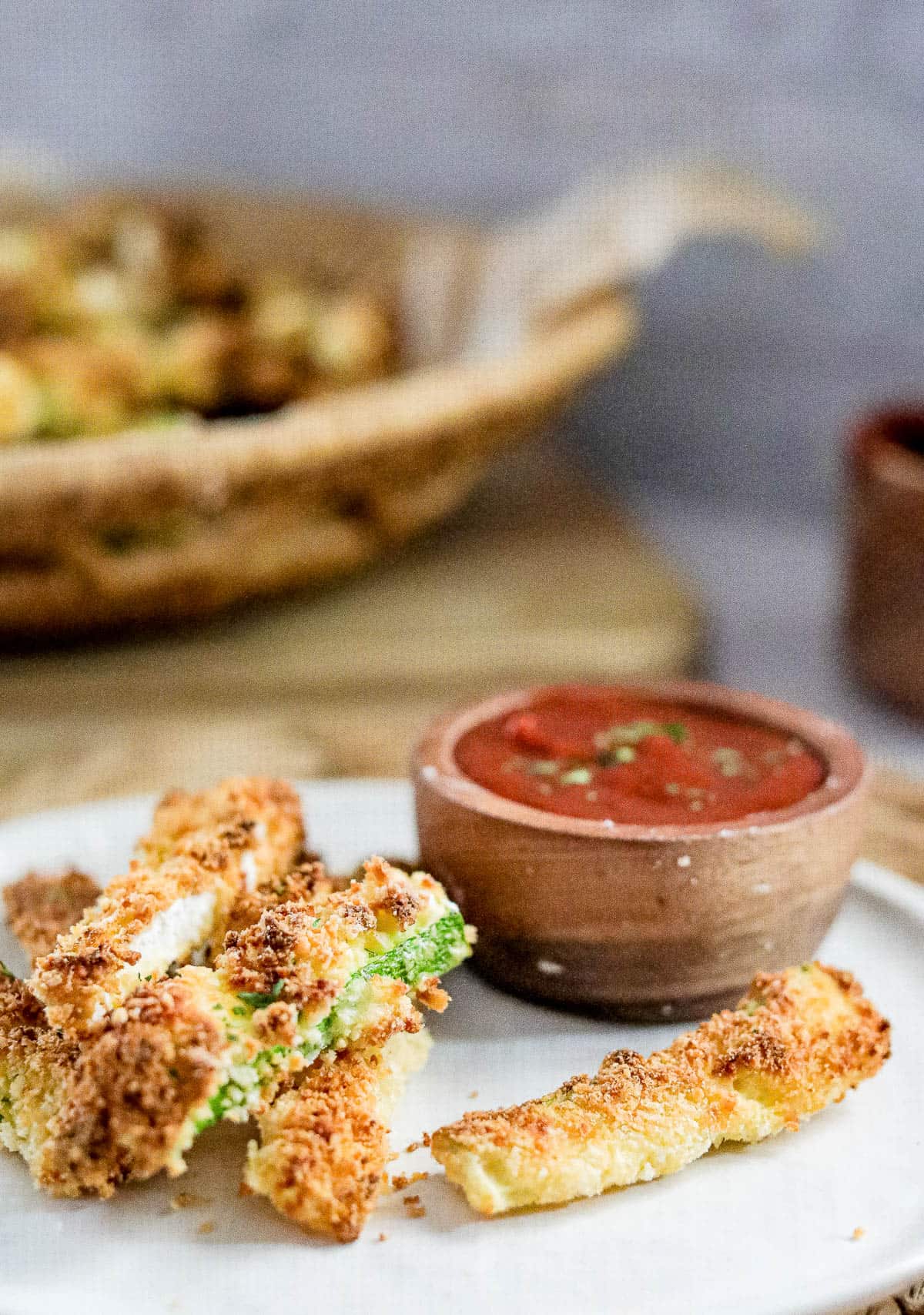 Low angle shot of a plate of air fryer zucchini fries.