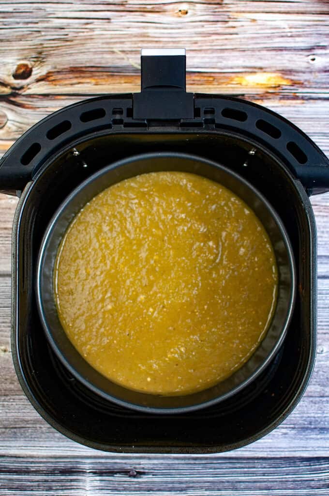 A bowl of enchilada sauce in an air fryer.