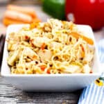 Low angle shot of a square bowl filled with ramen noodle stir fry.