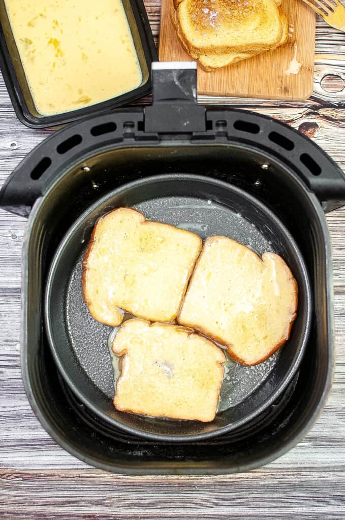 prepared french toast slices in the air fryer basket.