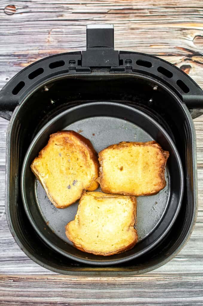 Cooked french toast in the air fryer basket.