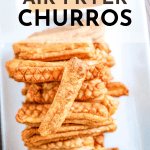 A stack of air fryer churros on a white plate labeled "crispy-licious." Indulge in the perfect blend of crunchy and sweet with these delightful air fryer churros.