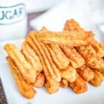 Air fryer churros on a white plate.