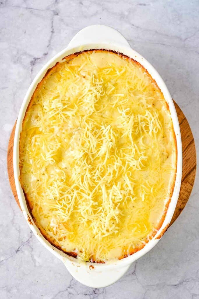 Partially baked potatoes au gratin with the cheddar cheese added on top.