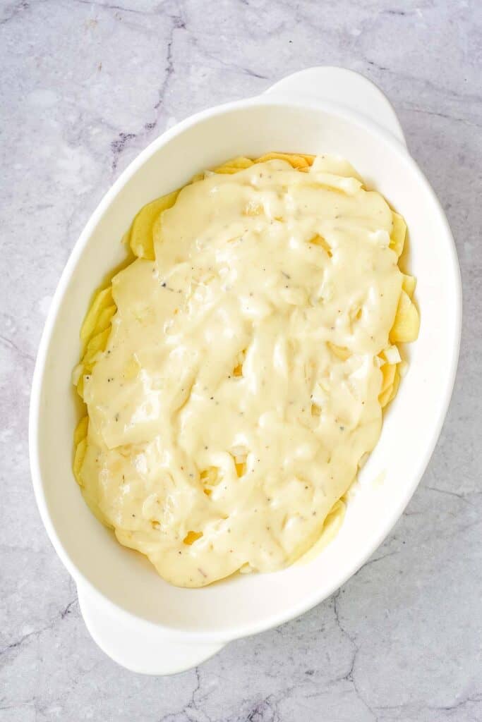 Cheese sauce over the potatoes and onions.
