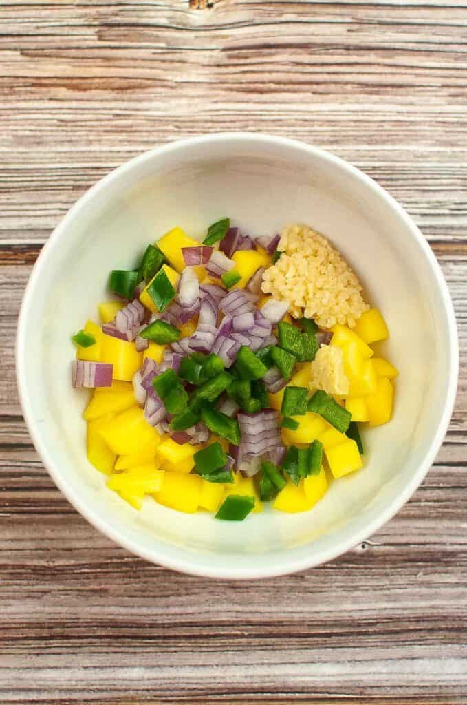Raw mango chutney ingredients in a food bowl.