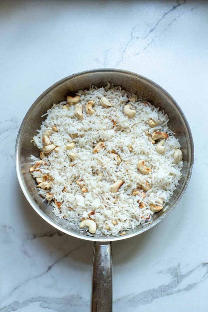 Rice and cashews added to the skillet.