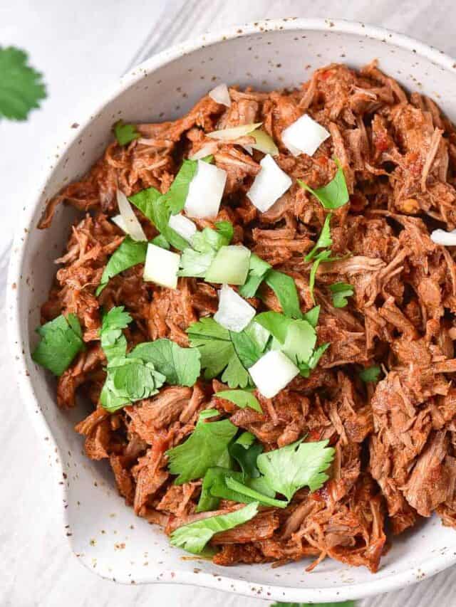 Mexican shredded beef in a white bowl.