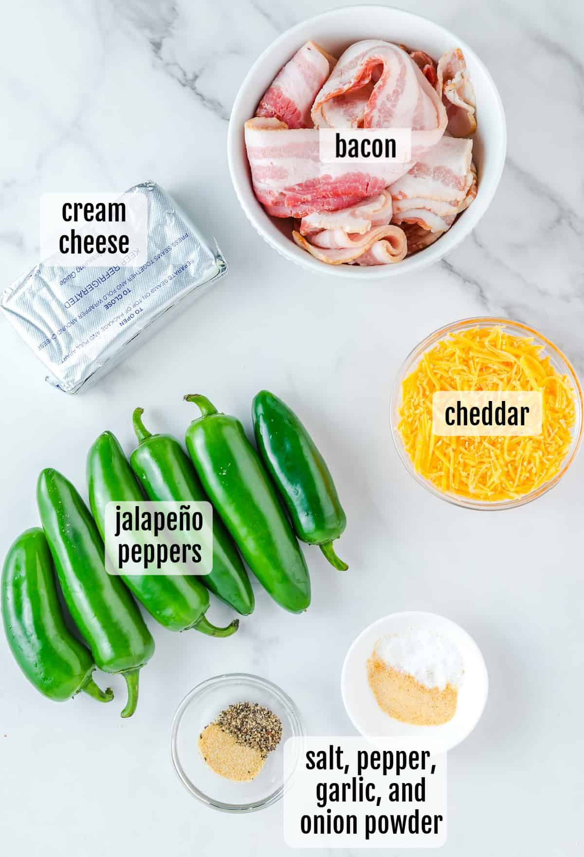 The ingredients for a jalapeno poppers are shown on a marble countertop.