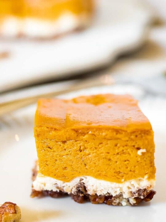 A slice of pumpkin cheesecake on a plate.