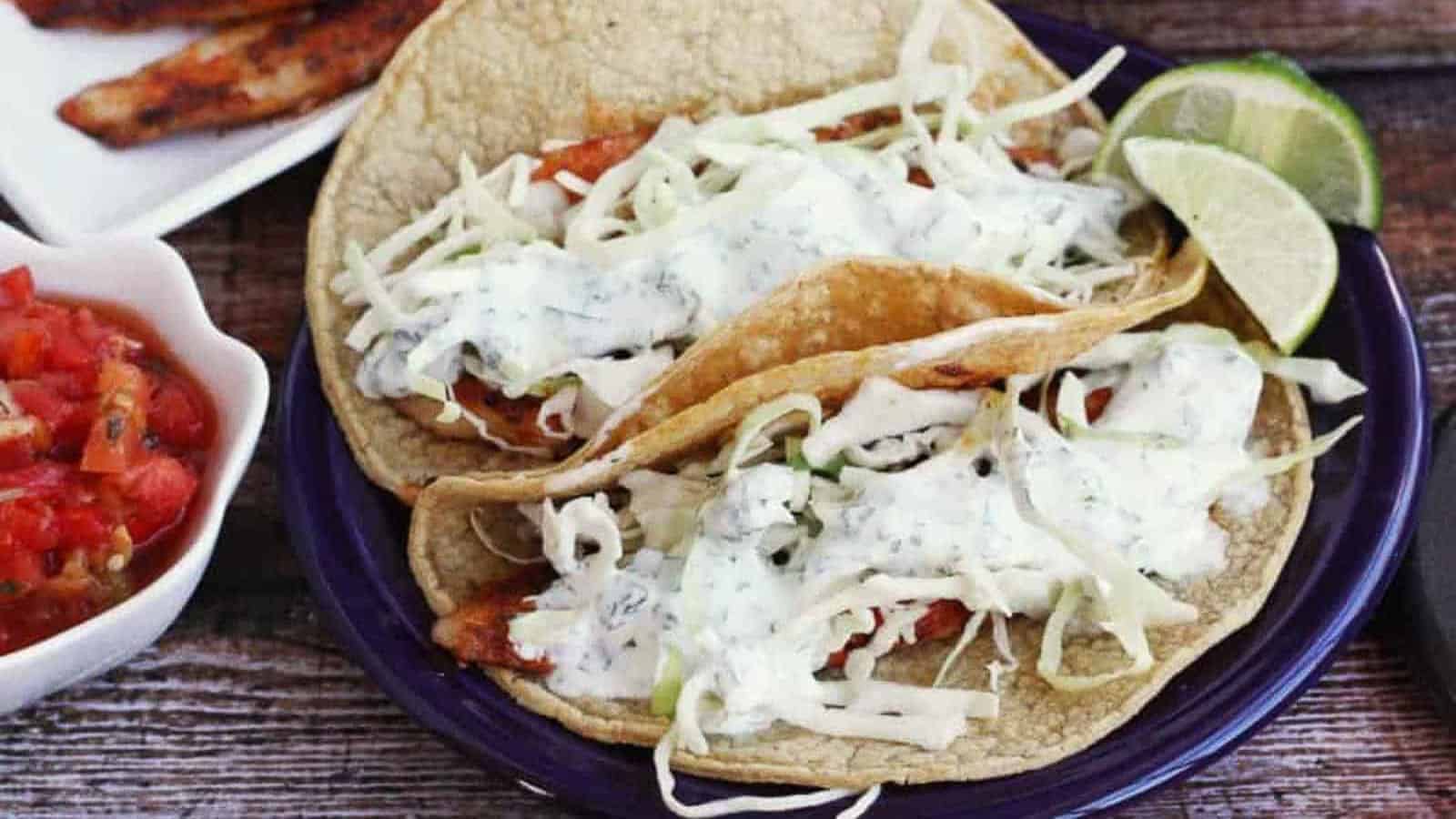 Fish tacos with shredded cabbage and cilantro lime crema.