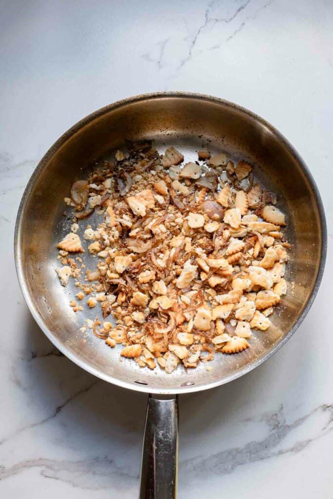 A frying pan with almonds in it.
