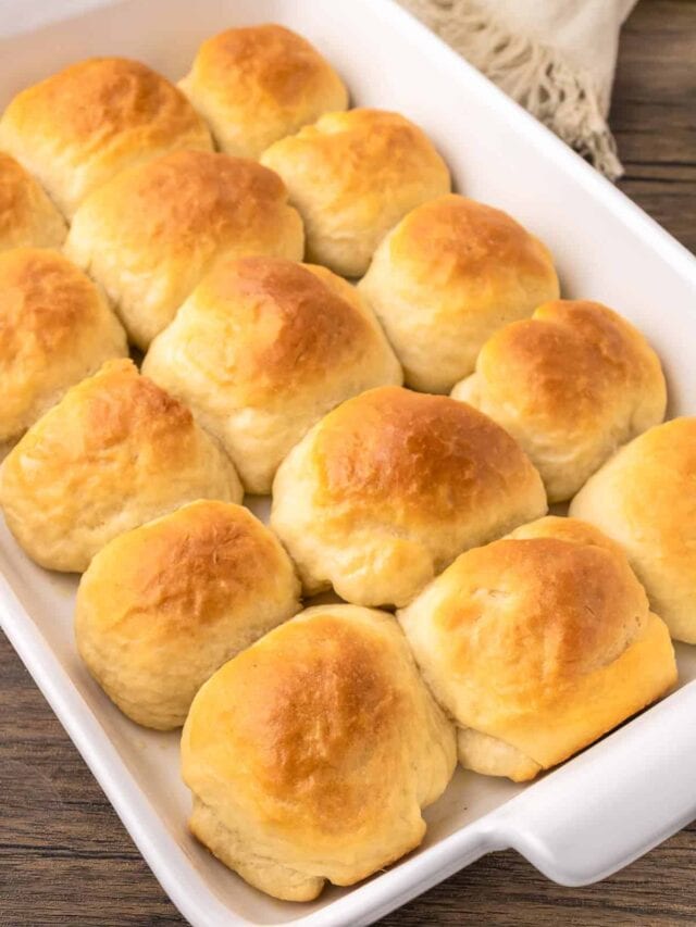 Rolls in a white baking dish on a table.