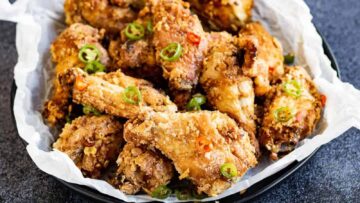 Basket of fried chicken with chilies and garlic.