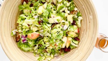 A bowl of brussels sprouts and apple salad.