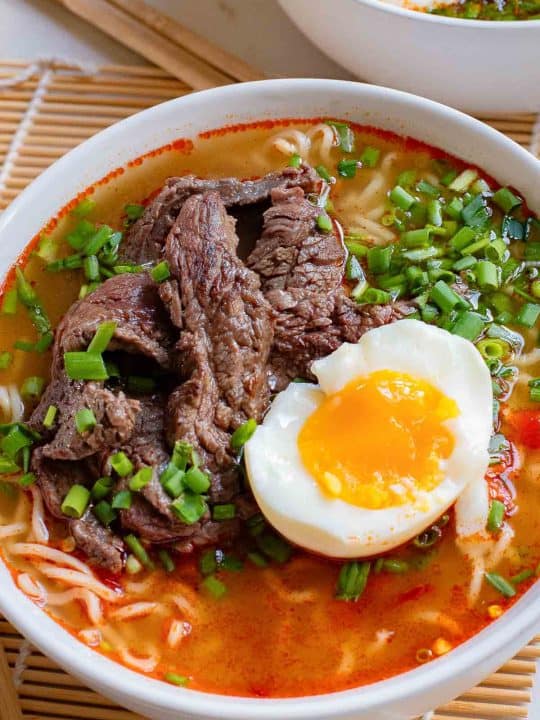 A bowl of Korean ramen with beef and an egg on top.
