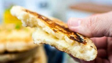 Superbowl Snacks - A person holding an arepa con queso.