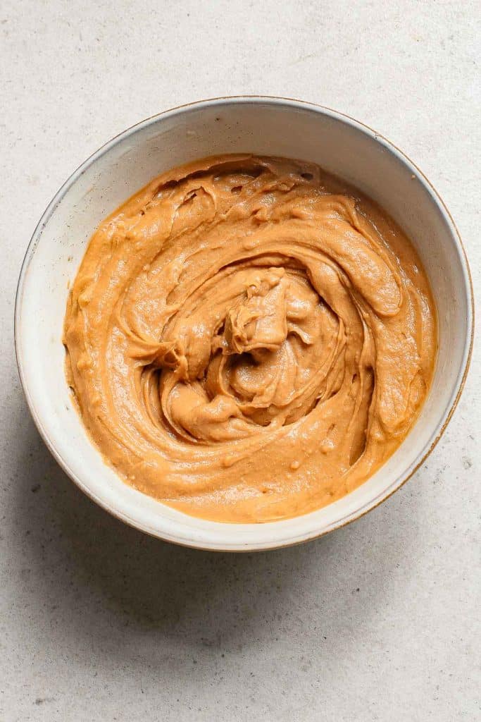 A bowl of creamy peanut butter.