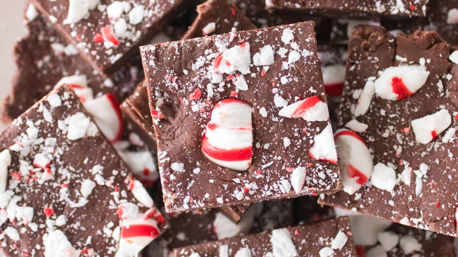 Close-up of chocolate peppermint bark squares topped with crushed candy canes.
