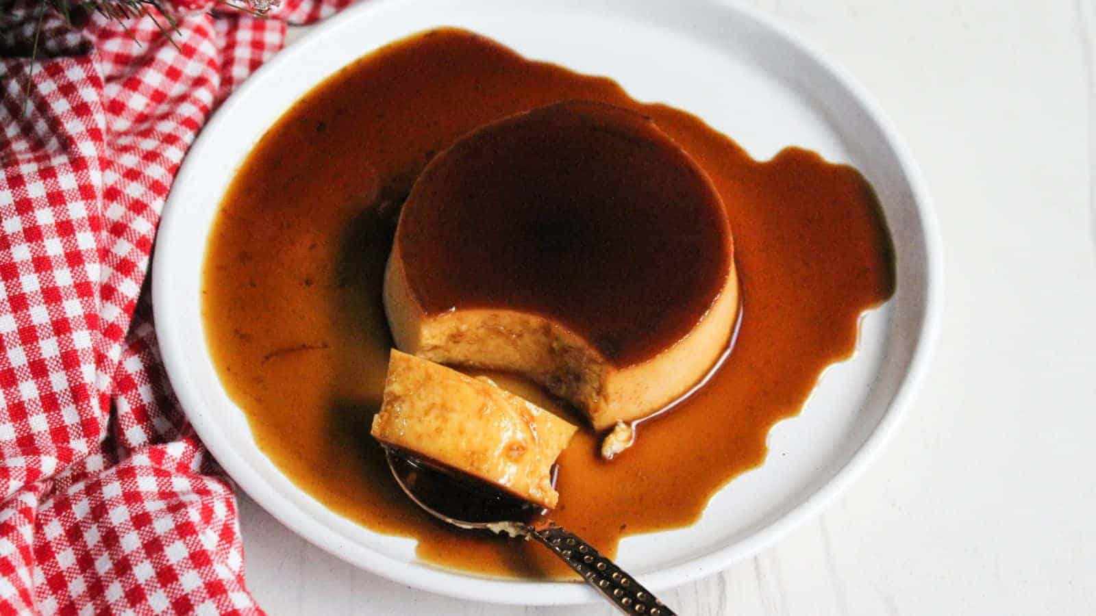 Leche flan caramel creme brulee on a plate with a spoon.